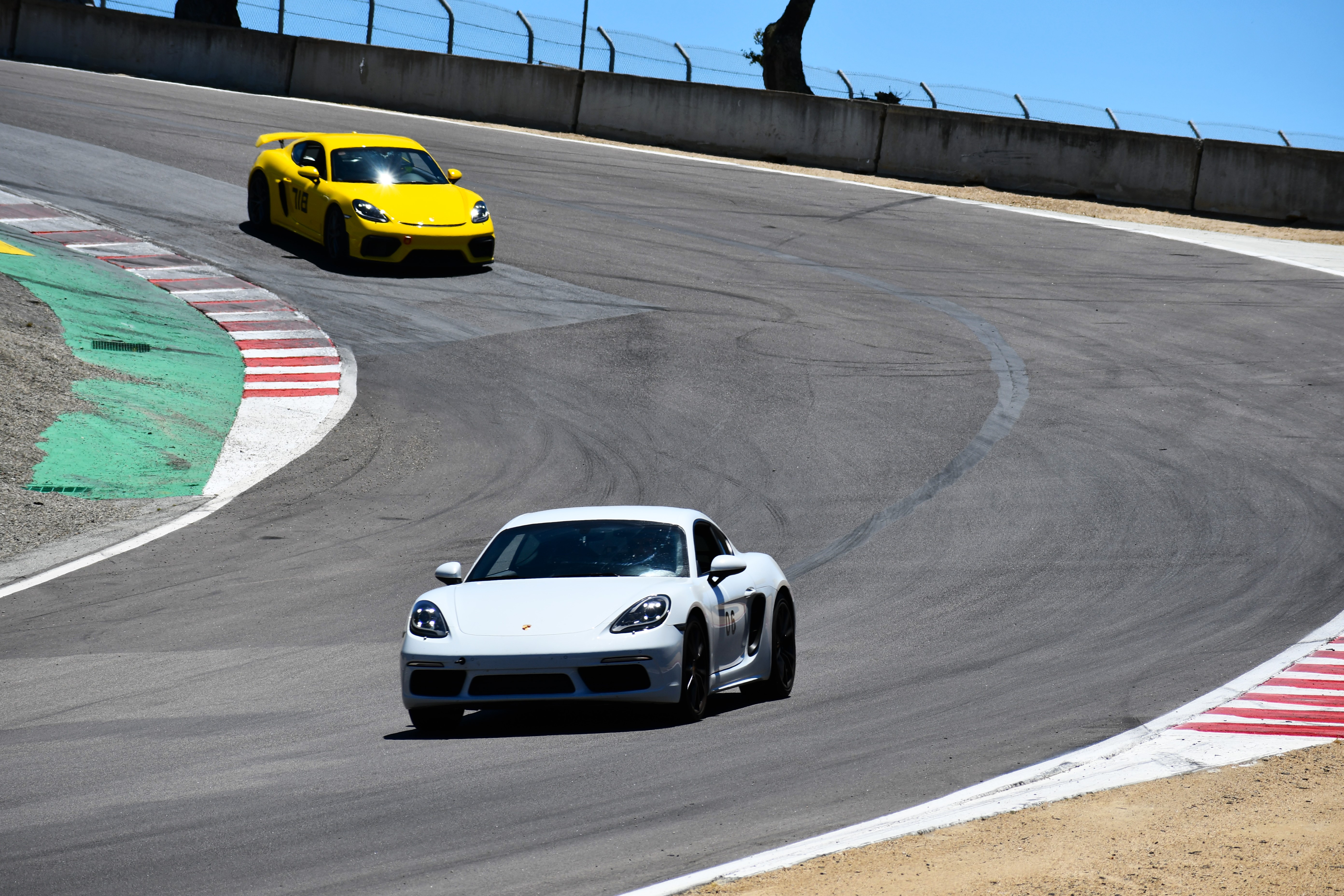 A white and yellow Porsche at WeatherTech Raceway Laguna Seca in Monterey, California.